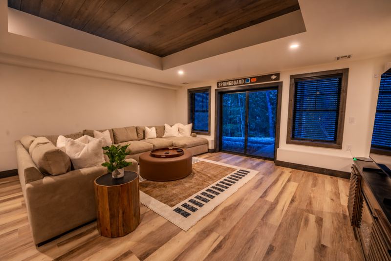 Lower-level family room with large sectional and sliders to the patio