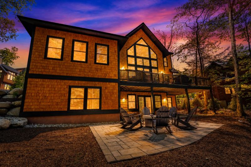 Rear elevation of the lodge lit at dusk